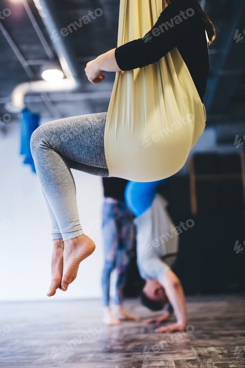 Preview: Aerial yoga couple training in hammock.