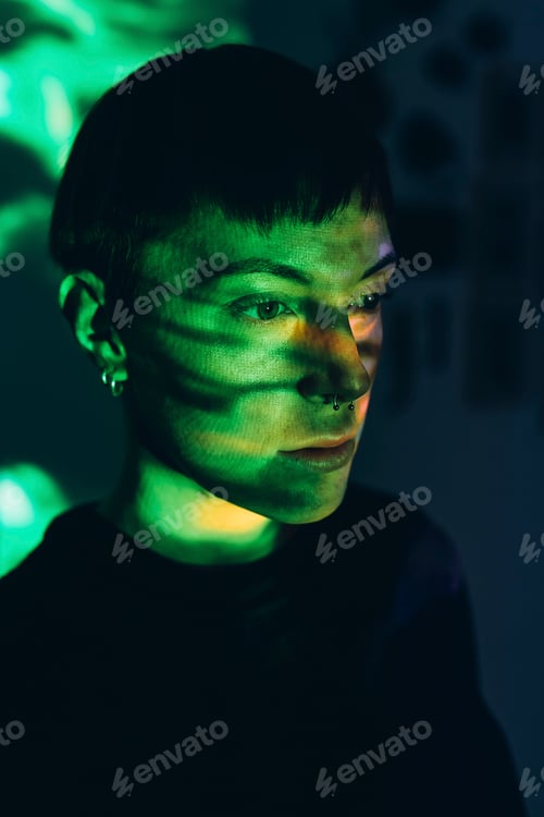 Preview: Woman daydreaming, green light reflected on face