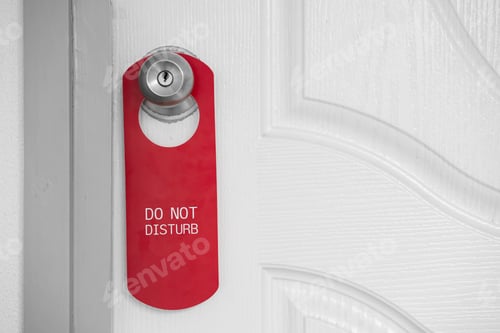 Preview: Close up banner sign hang on door with do not disturb text. design copy space for text.