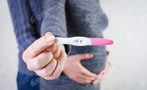 Preview: Young pregnant woman and her husband holding swollen belly with pregnancy test in her hand.