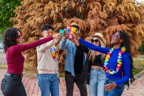Preview: A Multicultural Group of five Friends Celebrating with Colorful Drinks and Flower Necklaces.