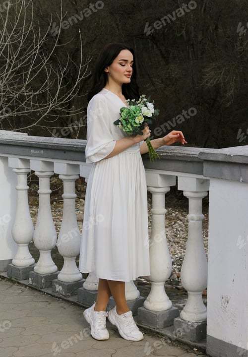 Preview: Young Woman in Dress and Sneakers with Flowers