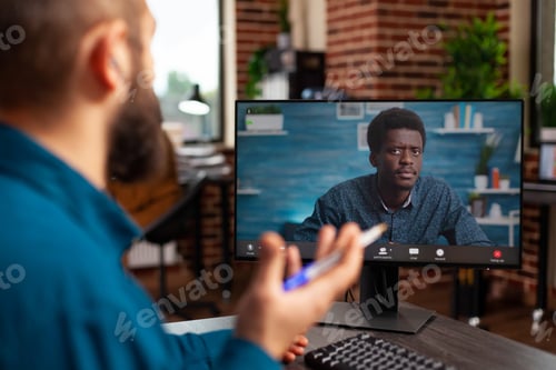 Preview: Businessman discussing marketing strategy with remote employee during online videocall