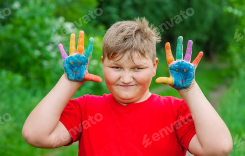 Preview: Smile on the hands of a child drawing. Selective focus. Kid.