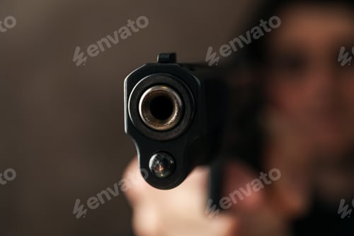 Preview: Man hold pistol. Selective focus. Robber. Violence
