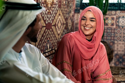 Preview: Young couple from Emirati spending time in a cafe