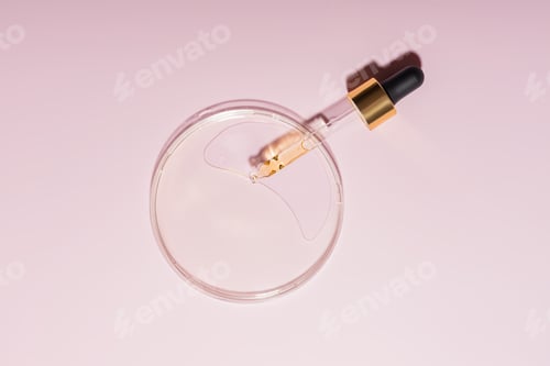 Preview: Pipette with sample of cosmetic product in petri dish on pink backgroud, Concept of lab research