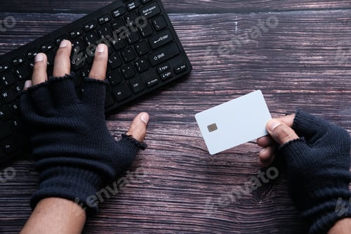 Preview: hacker hand stealing data from credit card