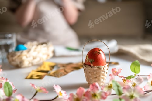 Preview: girl at home in the kitchen dyes eggs for Easter