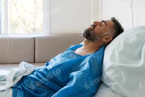 Preview: Patient man resting in hospital bed recovering healthcare