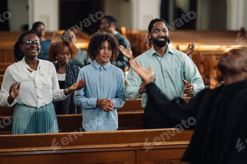 Preview: Group of people attending sermon and praying in church