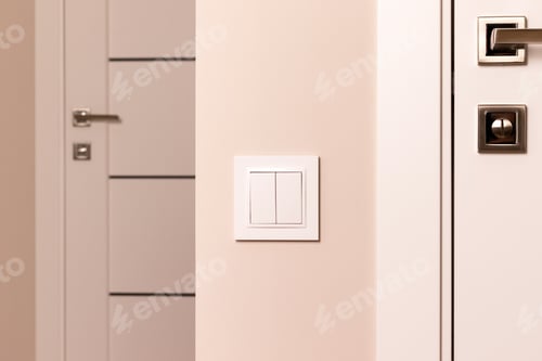 Preview: White electrical switch on beige wall