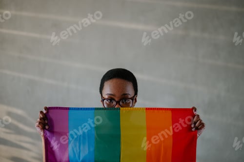 Preview: Portrait of a lesbian african american woman holding gay lgbt flag