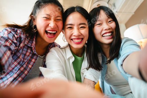 Preview: Happy beautiful chinese women friends bonding at home