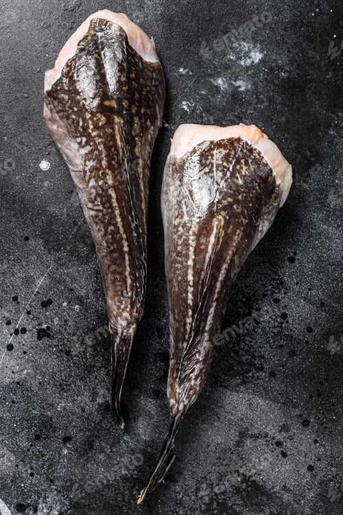 Preview: Fresh monkfish without a head. Black background. Top view