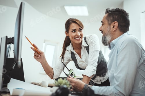 Preview: Business Colleagues Discussing Work at Office Desk