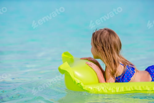 Preview: Adorable little girl on air inflatable mattress in the sea