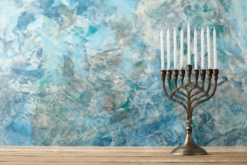 Preview: Happy Hanukkah. Hanukkah old Menorah against background of the Israeli flag with sunlight or bokeh o