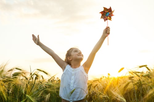 Preview: Little girl playing on the meadow in wheat field.