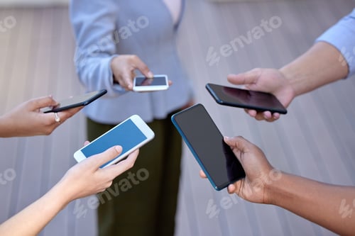 Preview: Shot of a group of business people holding an array of smartphones