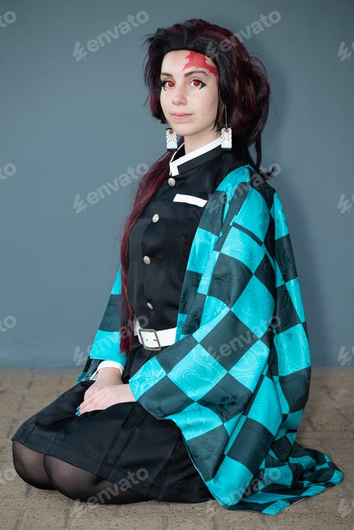 Preview: Caucasian female cosplayer in a blue costume with face paint and red contact lenses