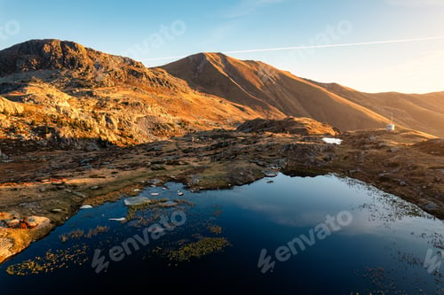 Preview: Sunrise shine over Lac Guichard with rocky mountain in autumn at France