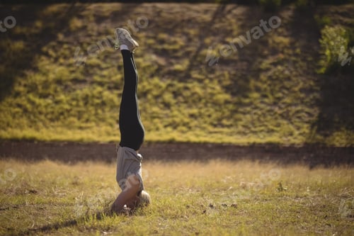 Preview: Woman performing headstand during obstacle course