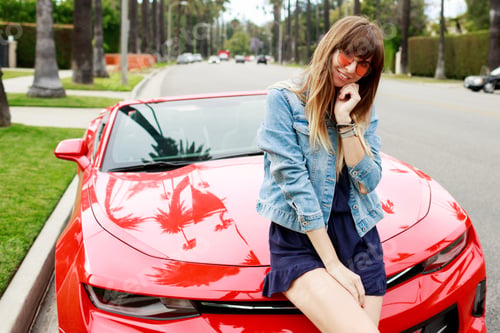 Preview: Lifestyle image of travel female sitting on the car