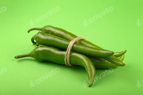 Preview: Bunch of jalapeno hot chili peppers on green
