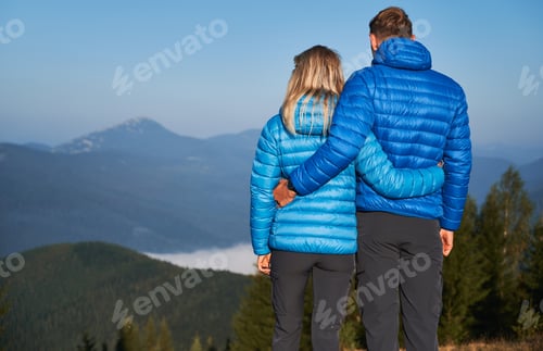 Preview: Family couple admiring beautiful mountain scenery.