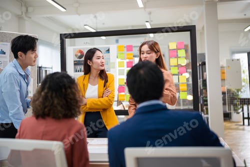 Preview: Group of young Asian business people team meeting in modern office working