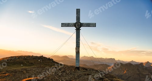 Preview: Scenic shot of the Goesseck summit cross during the sunset at Eisenerzer Alps