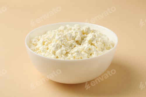 Preview: Bowl with fresh cottage cheese on beige background