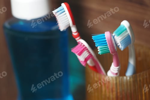 Preview: Vibrant toothbrushes and mouthwash on a bathroom shelf