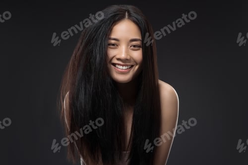 Preview: portrait of happy asian woman with beautiful and healthy dark hair looking at camera isolated on