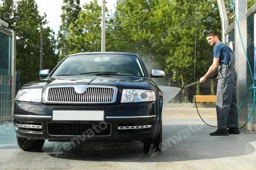 Preview: A man washes a car in a manual car wash. Clear car