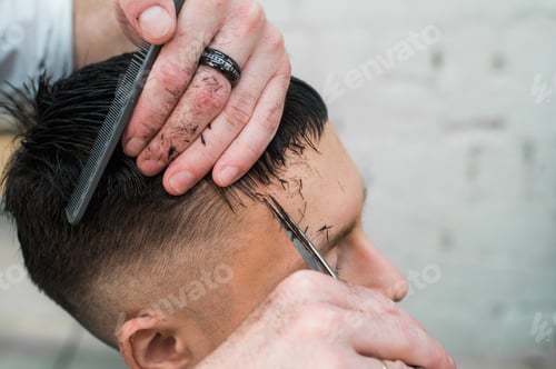 Preview: close up shot of man getting his hair cut
