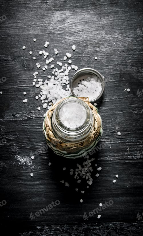 Preview: Coarse salt in saltcellar. On black rustic background.