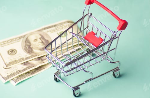 Preview: shopping cart in the store and money for shopping on sale