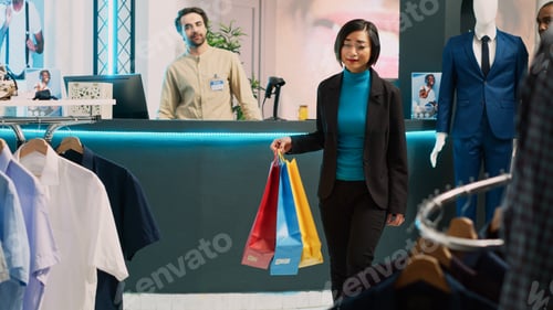 Preview: Female customer enjoying buying clothes from retail shop