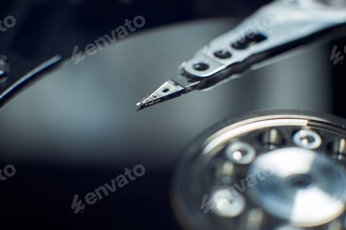 Preview: Disassembled hard disk. Read head, magnetic disk and spindle close-up.