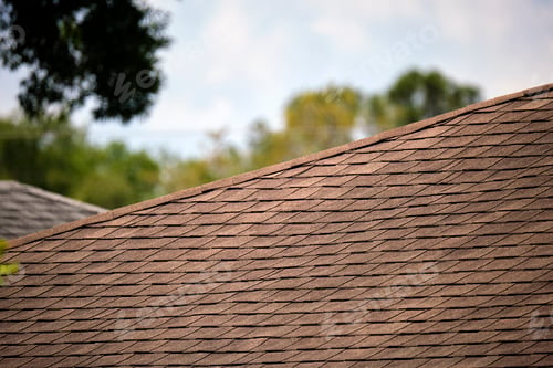 Preview: Closeup of house roof top covered with asphalt or bitumen shingles