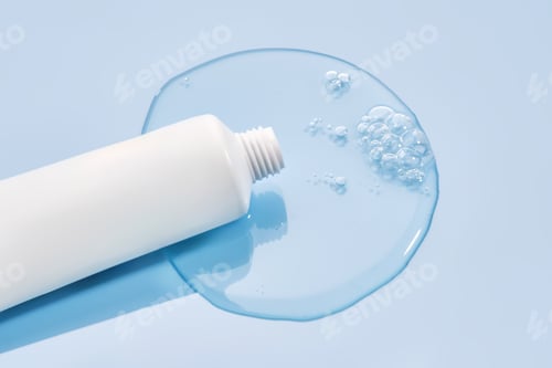 Preview: Shampoo pouring out of a small tube on a blue background. Texture.