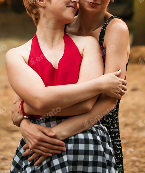 Preview: Two enamored lesbians hug. Happy LGBTI couples walking.