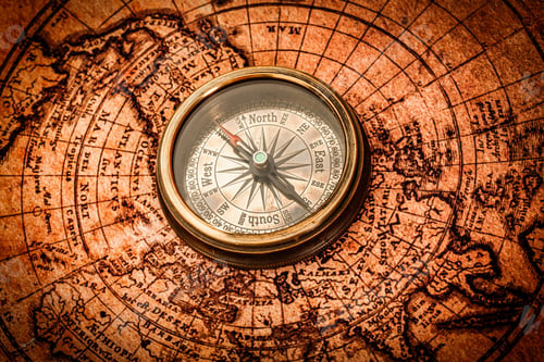 Preview: Vintage compass lies on an ancient world map.