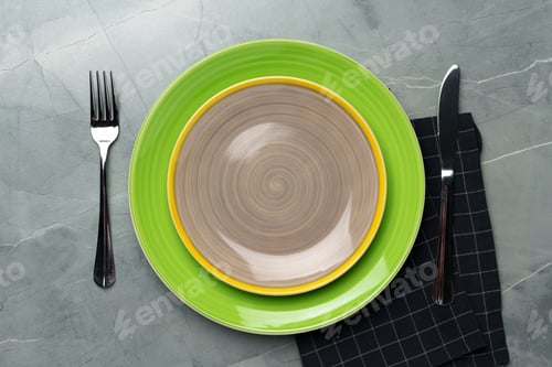 Preview: Top view of ceramic plate with table napkin on gray background