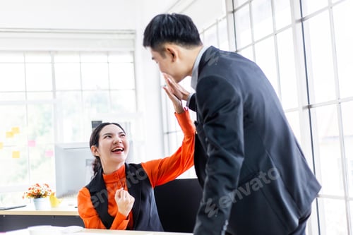 Preview: Happy successful Asian business man and woman giving high five for project success