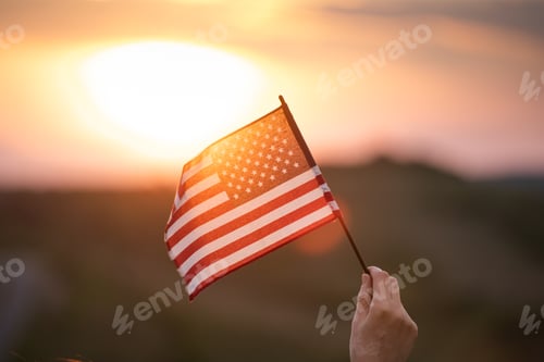Preview: American Flag held against a Sunset Sky