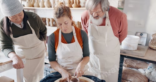 Preview: Pottery, group and teacher mold clay in studio or workshop learning with instructor woman, coach or