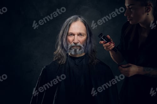 Preview: Woman with electric clipper cutting hairs of old man